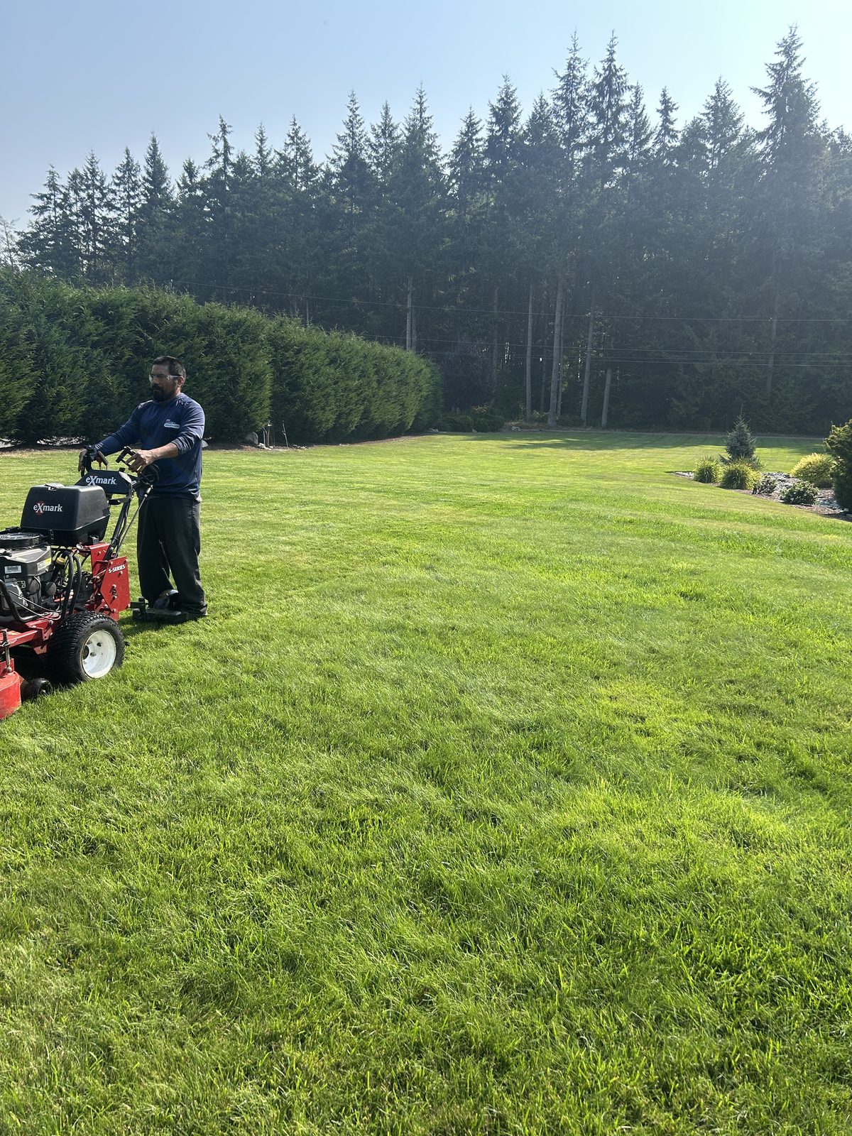 ZNS Landscaping crew member mowing a residential lawn