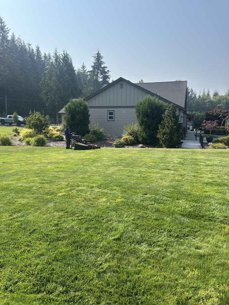 Large estate lawn and landscaped beds maintained by ZNS Landscaping